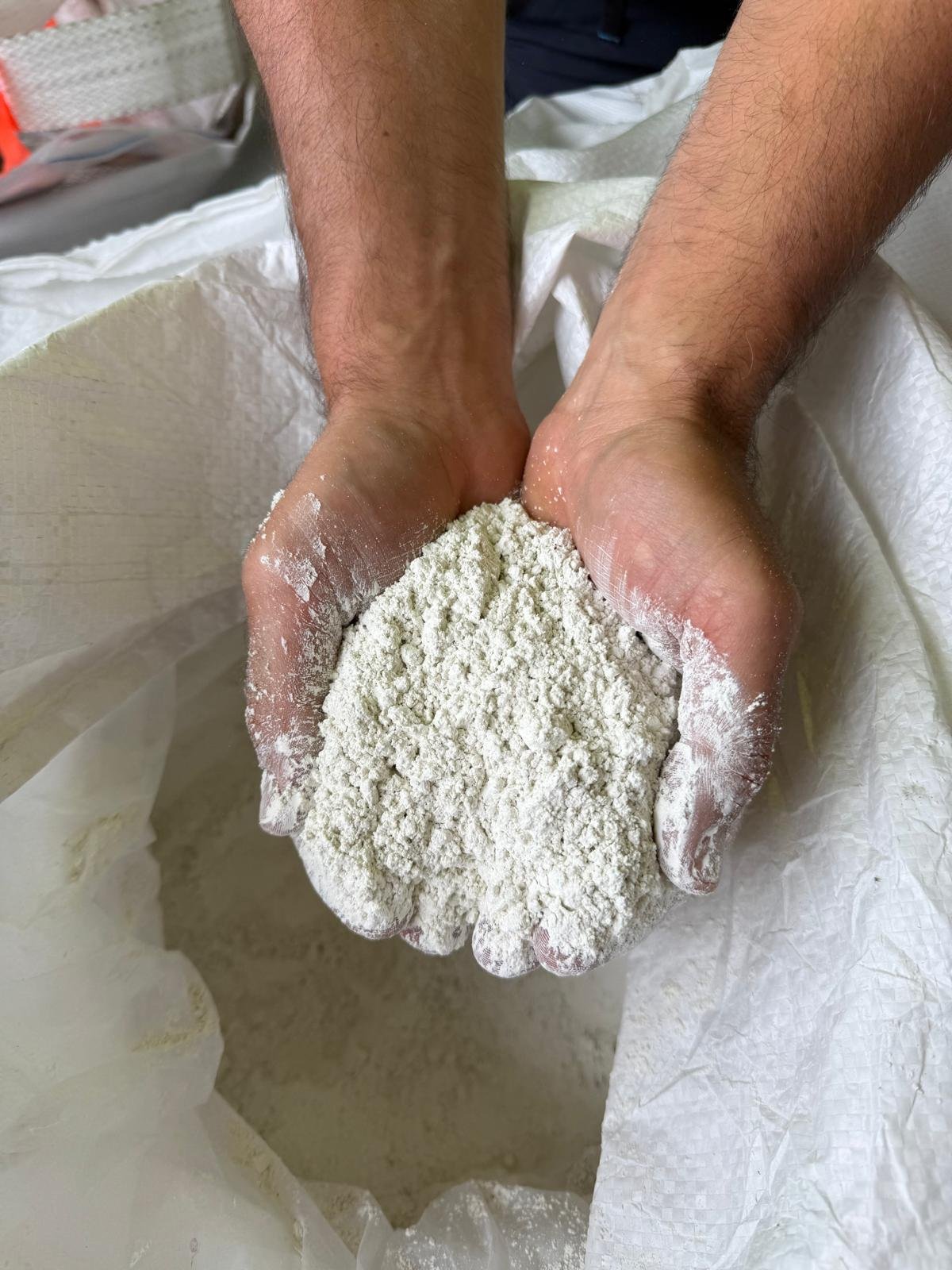 ECOFUME 5-micron powder held in bare cupped hands at the batch plant